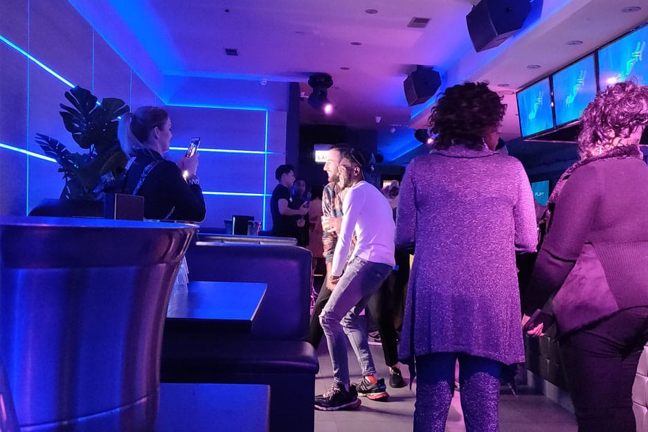 People taking photos in front a Social Photo Booth at a Restaurant